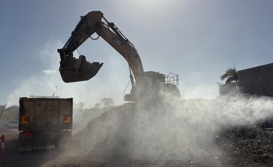 Excavator working through dust at the Grand Plaza cinema demolition, Browns Plains