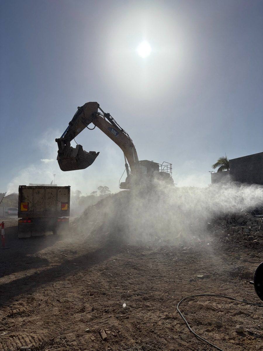 Excavator working through dust at the Grand Plaza cinema demolition